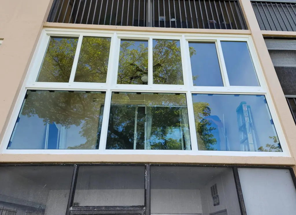 Impact window replacement on a two-story residential building